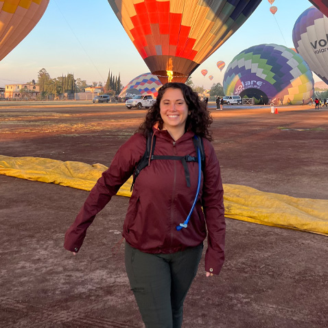Tasha in front of hot air balloons